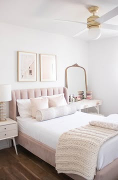 a bedroom with a bed, dresser and mirror in it's centerpieces