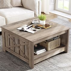 a living room with a couch, coffee table and bookshelf on the floor