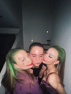 three girls with green hair are posing for the camera