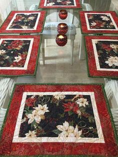 the table is set with four placemats and two candle holders on each side