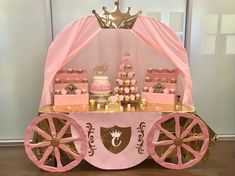 a pink and gold princess carriage dessert table