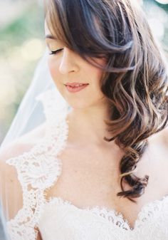 a woman in a wedding dress with a veil on her head