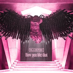 an artistic display with black wings and pink lighting