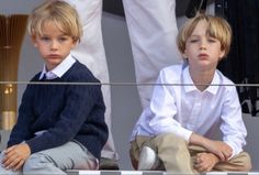 two young boys sitting next to each other