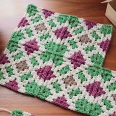 a crocheted dishcloth is sitting on a table