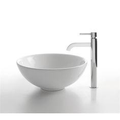 a white bowl sink sitting next to a faucet