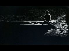 a man in a boat on the water at night