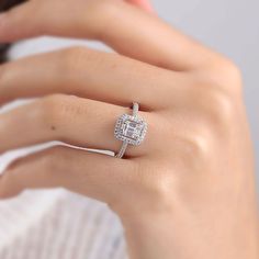 a woman's hand with a diamond ring on it