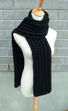 "This beautiful hand knitted scarf is made with Super Bulky and Soft Wool Blend Yarn (80% Acrylic, 20% Lambswool). Classic ribbed pattern, it looks the same on both sides. The scarf can be worn in multiple ways. Amazing color for the fall/winter season. It goes with everything. The color may appear slightly different on different monitors. Measures: 63\" (160 cm) long x 7\" (17 cm) wide. From a smoke-free home. Care instructions: Hand wash in cool water and dry flat." Black Scarf Aesthetic, Handmade Black Scarf For Fall, Handmade Black Scarves For Fall, Handmade Knit Scarves For Winter, Winter Hand Knitted Black Knitting Pattern, Hand Knitted Acrylic Yarn Scarf For Cold Weather, Hand Knitted Acrylic Yarn Scarves For Cold Weather, Black Knitted Scarves For Winter, Black Knitted Scarf For Winter