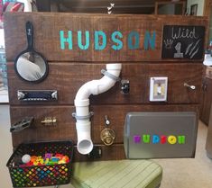 there is a wooden sign that says hudson on it and some other things in front of it