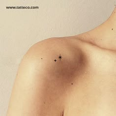 a small star tattoo on the back of a man's left shoulder and chest