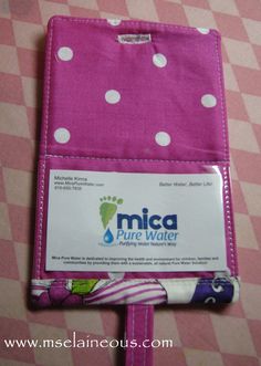 a pink and white polka dot cloth with a name tag on the front of it