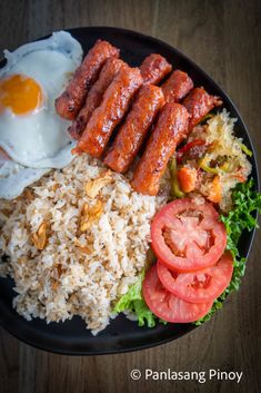 the plate has rice, meat and vegetables on it with an egg in the middle