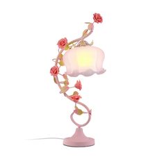 a pink table lamp with roses on it and a white shade over the light fixture