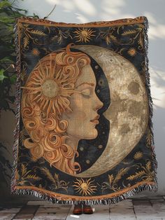 a tapestry with a woman's face on the moon and stars in the sky