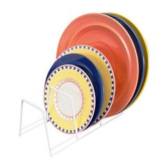 a stack of colorful plates sitting on top of a metal rack with two white handles