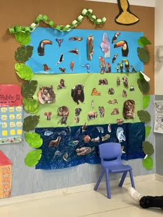 there is a blue chair sitting in front of a bulletin board with animals on it