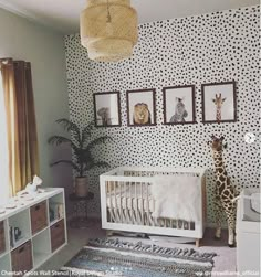 a baby's room with giraffes and zebra prints on the wall