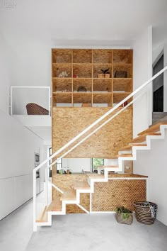 the stairs in this modern house are made out of plywood and white wood panels