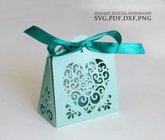 a blue box with a bow on it that is cut out to look like an ornament