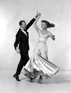 a man and woman dancing together in an old photo