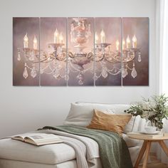 a living room scene with focus on the couch and chandelier canvas wall art