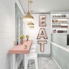 a white and pink kitchen with some lights on the wall next to it's counter