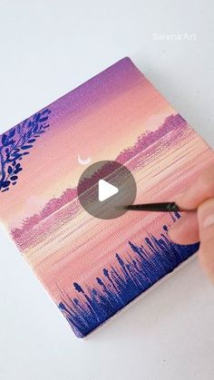 someone is painting a sunset scene with acrylic paint