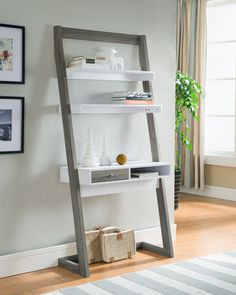 Setup a modern workspace in any home setting thanks to the Boreggo desks slim space-saving design. Finished in distressed gray and complemented by brilliant white accents, the desk features spacious upper shelves for storing books, showcasing decor and more. Work with ease on the generous tabletop and store everyday use items in the open shelf or discreetly in the ample drawer. Resting securely against any wall, the Boreggo desk is a clever modern office companion that helps elevate your work fl Anniversary Post, Leaning Ladder Desk, Leaning Desk, Leaning Shelf, Ladder Desk, Wood Writing Desk, Contemporary Desk, Stand Up Desk, White Shelves