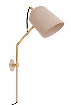 a white and gold desk lamp with a black cord attached to it's arm