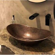 a bathroom sink sitting on top of a marble counter