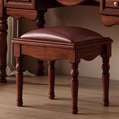 a wooden desk with a brown leather seat