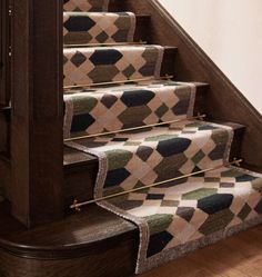 the carpeted stair treads on this staircase are made from wood and have diamond patterns