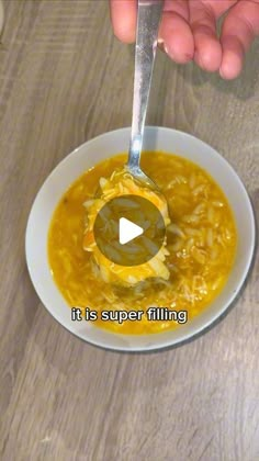 a person holding a spoon over a bowl of soup with the words it is super filling