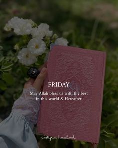 a person holding a pink book with white flowers in front of it that says friday