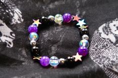 Asexual pride flag star beaded gemstone bracelet. The beads are the asexual flag colors (black, grey, white, purple) and holographic stars.  ♥ Bracelet Size: - To find the size that fits you best, you can measure the circumference around your wrist; for a comfort/loose fit, add 2cm to that measurement ♥ Handcrafted With: ✔ High-quality gemstone beads ✔ Durable stretchy cord Thank you for visiting! If you have any questions, feel free to contact me!  Instagram: @FrogsMakingToast Asexual Ring, Lgbtq Gifts, Lgbtq Jewelry, Asexual Flag, Stretchy Beaded Bracelet, Pride Bracelet, Asexual Pride, Flag Colors, Pride Flag