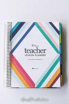 the teacher lesson planner is open on top of a white surface with colorful lines in it