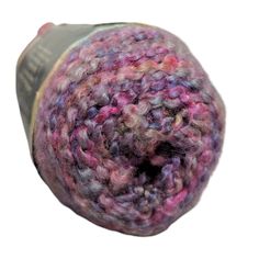 a ball of yarn sitting on top of a white surface with the end of it's spool