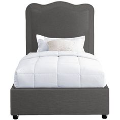 a bed with a white comforter and pillows on it's headboard, in front of a white background