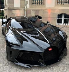 a black sports car parked in front of a building