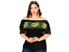 a woman in black top with sunflowers on the shoulder and yellow tassel