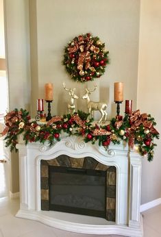 a fireplace decorated for christmas with candles and decorations