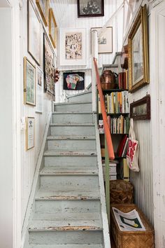 the stairs are painted blue and have pictures on them, along with bookshelves