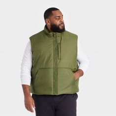 Why we're ALL IN: Puffer vest is designed to keep you warm and cozy wherever your day takes you. Made from 100% recycled polyester with a puffer construction. Full-length front zipper provides a snug fit and allows for easy layering. Front pockets offer space for your small on-the-go essentials. All in Motion™: Inspiring the potential in every body. Mens Puffer Vest, All In Motion, Vests Mens, Recycled Polyester Fabric, Mens Green, Puffer Vest, Mens Vest, Mens Activewear, Casual Fits