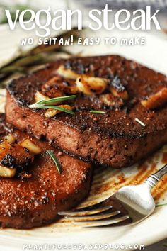 two pieces of steak on a plate with fork and knife next to it that says vegan steak no setian easy to make