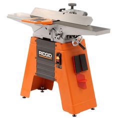 a table saw is sitting on top of an orange stand