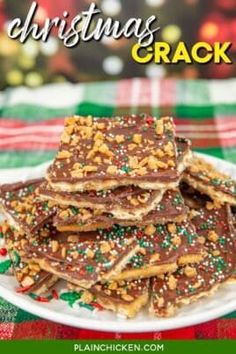 a white plate topped with chocolate covered crackers on top of a green and red checkered table cloth