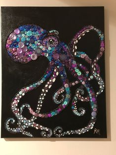 an octopus made out of buttons on a black canvas with purple, blue and green accents