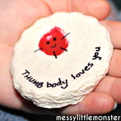 a hand holding a white rock with a red ladybug on it and the words hump baby loves you