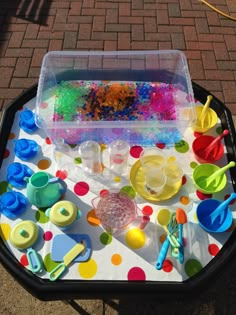 the table is covered with plastic toys and confetti